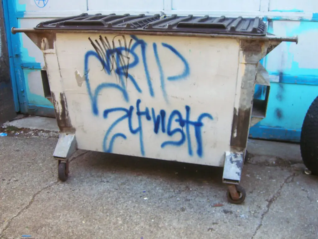Crips graffiti on a dumpster bin