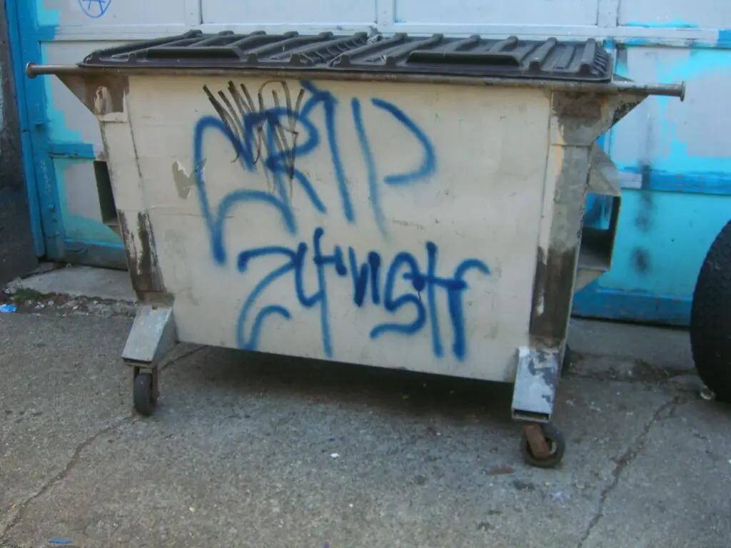 Gang graffiti on a garbage bin