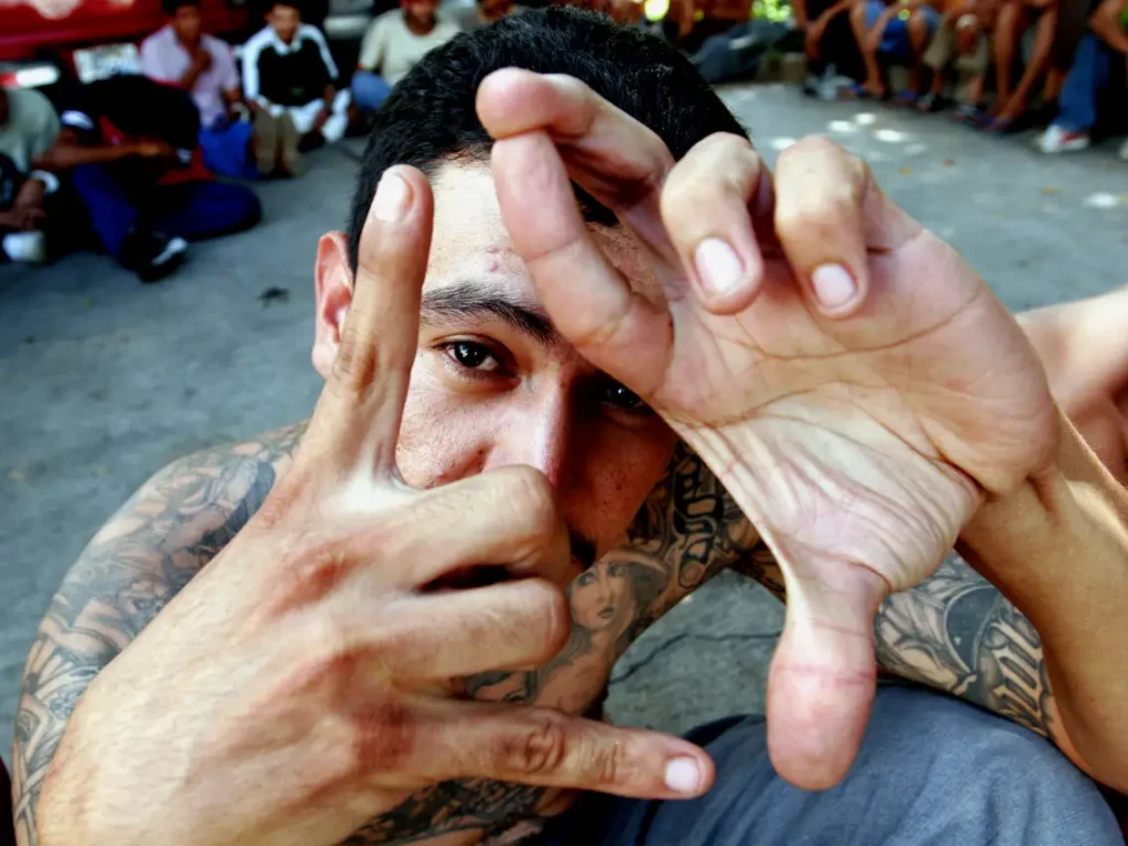 MS-13 member showing M and S gang sign using his both hands