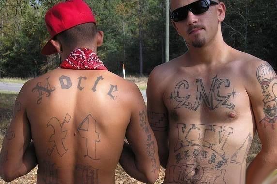 Two Norteños gang members showing their tattoos