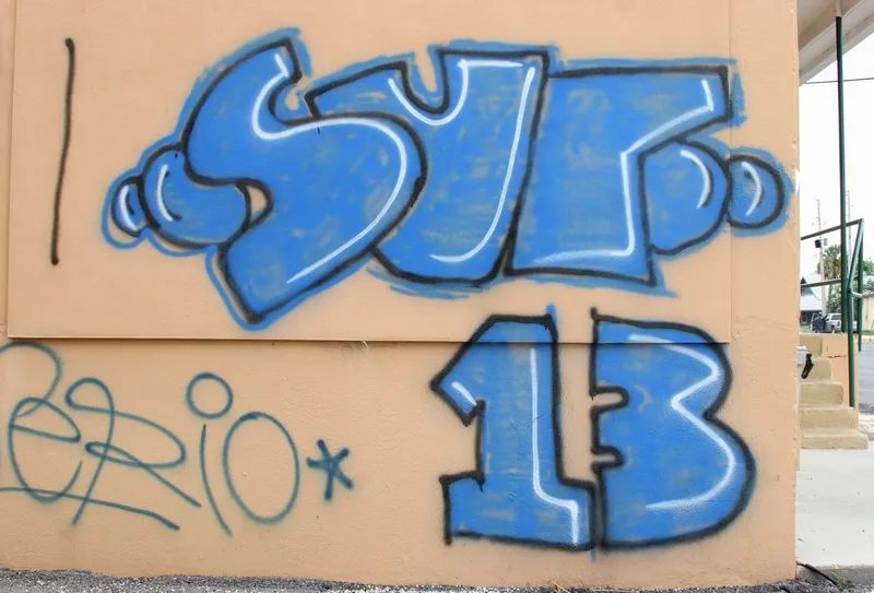SUR 13 blue color graffiti on a building