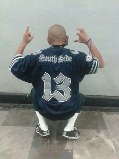 A gang member wearing blue color outfit with Surenos symbols all over it